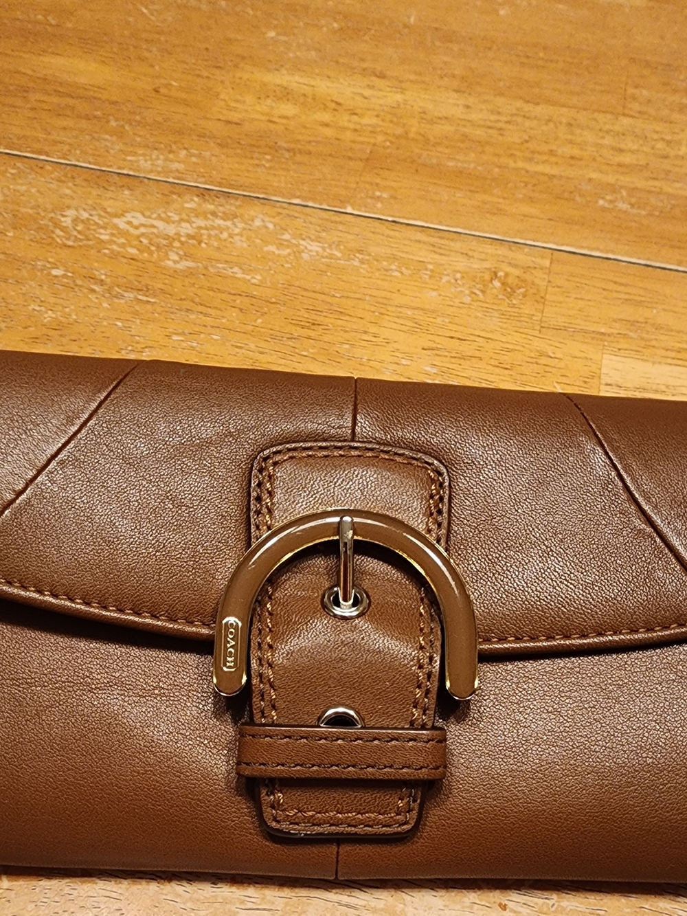 vintage Coach Soho Buckle Wallet crafted in brown leather prominent front Buckle